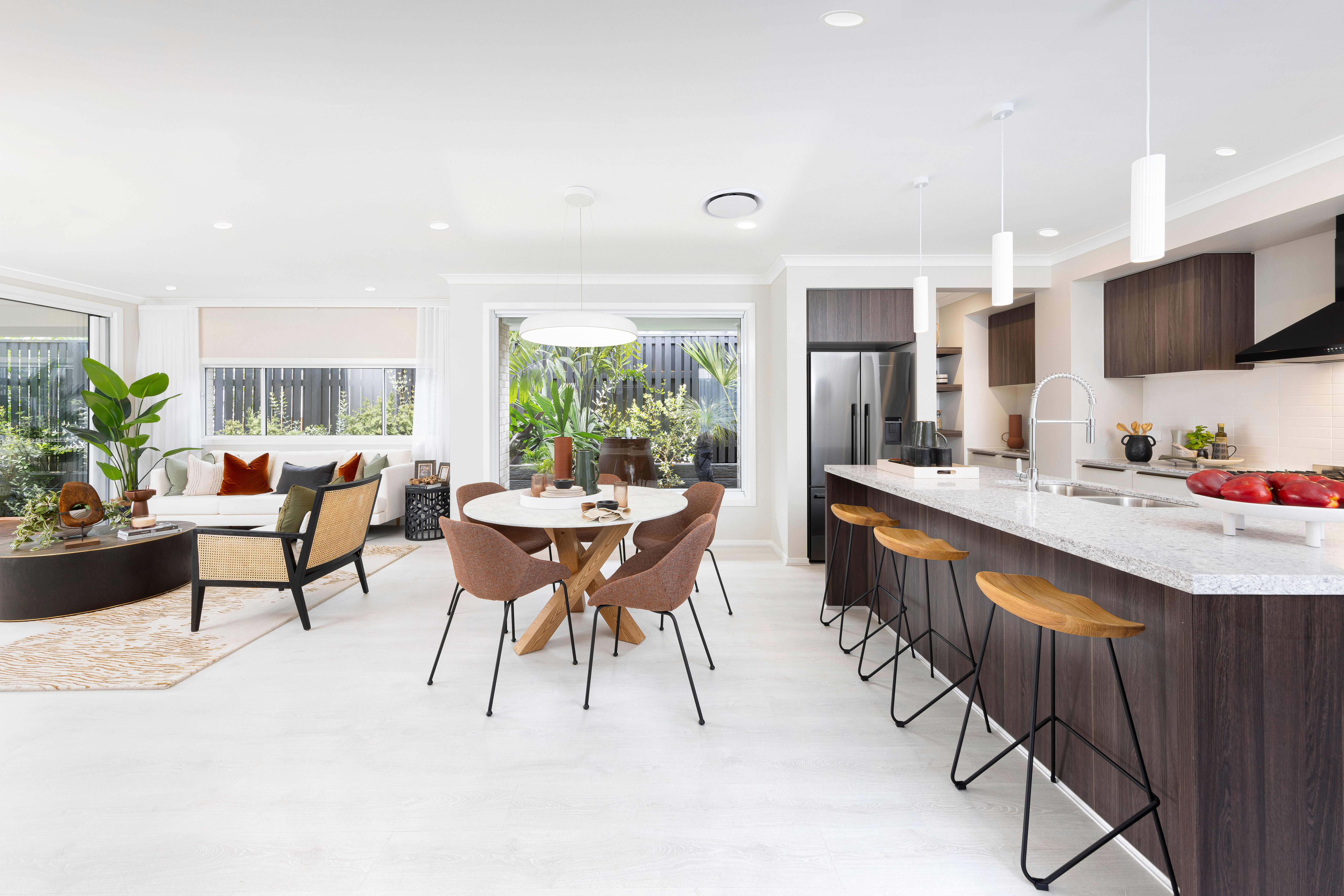 Brighton Homes living, dining and kitchen area with garden-facing windows.