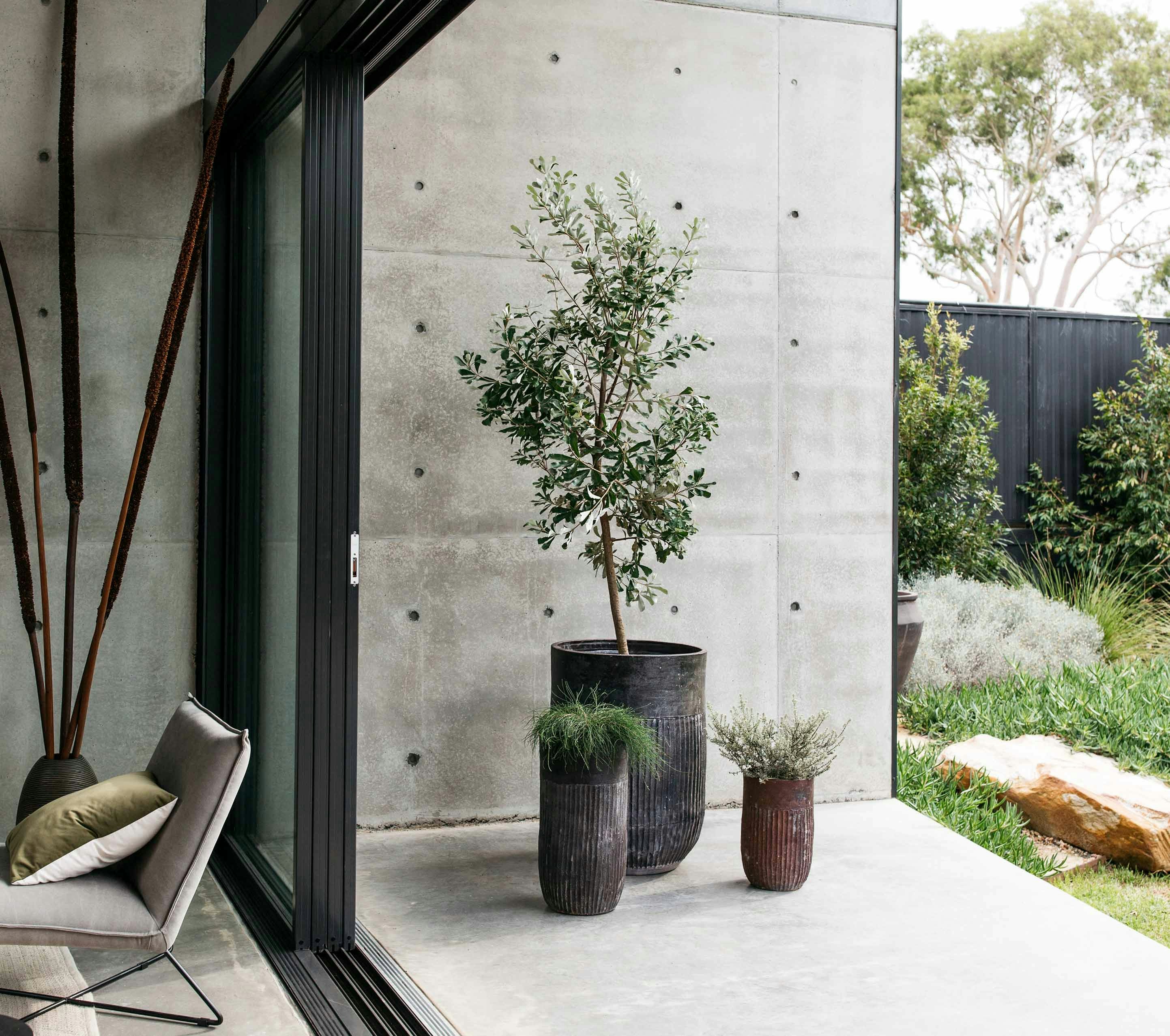 Potted plants and outdoor decor beside an open living area.